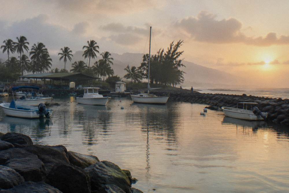 Small boats moored at a harbor entrance on Oahu's North Shore