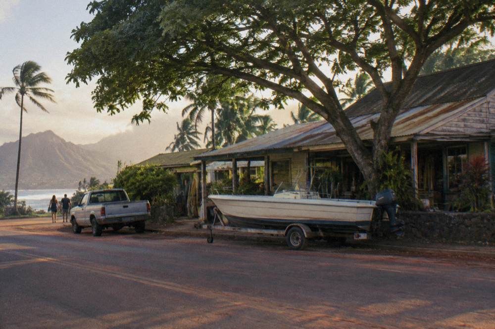 Small boat at a harbor dock near a coastal town