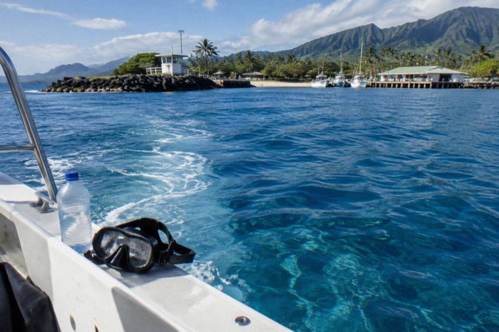 Clear deep blue open ocean water seen from a boat deck three miles offshore of Oahu