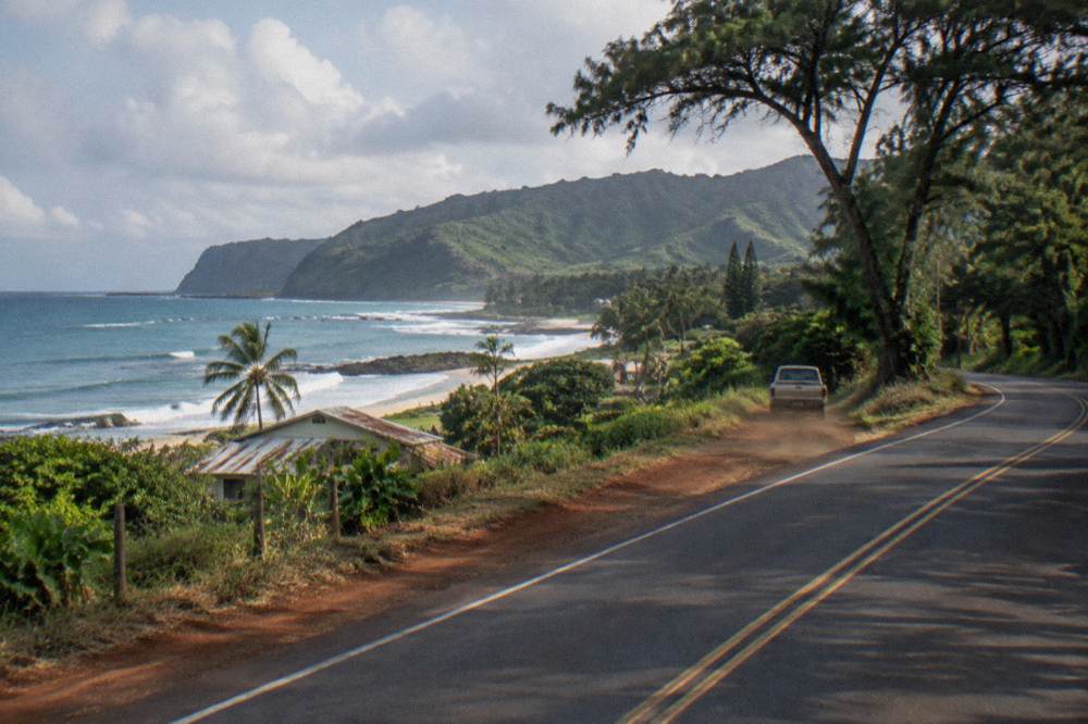 A coastal highway winding along the North Shore of Oahu at morning
