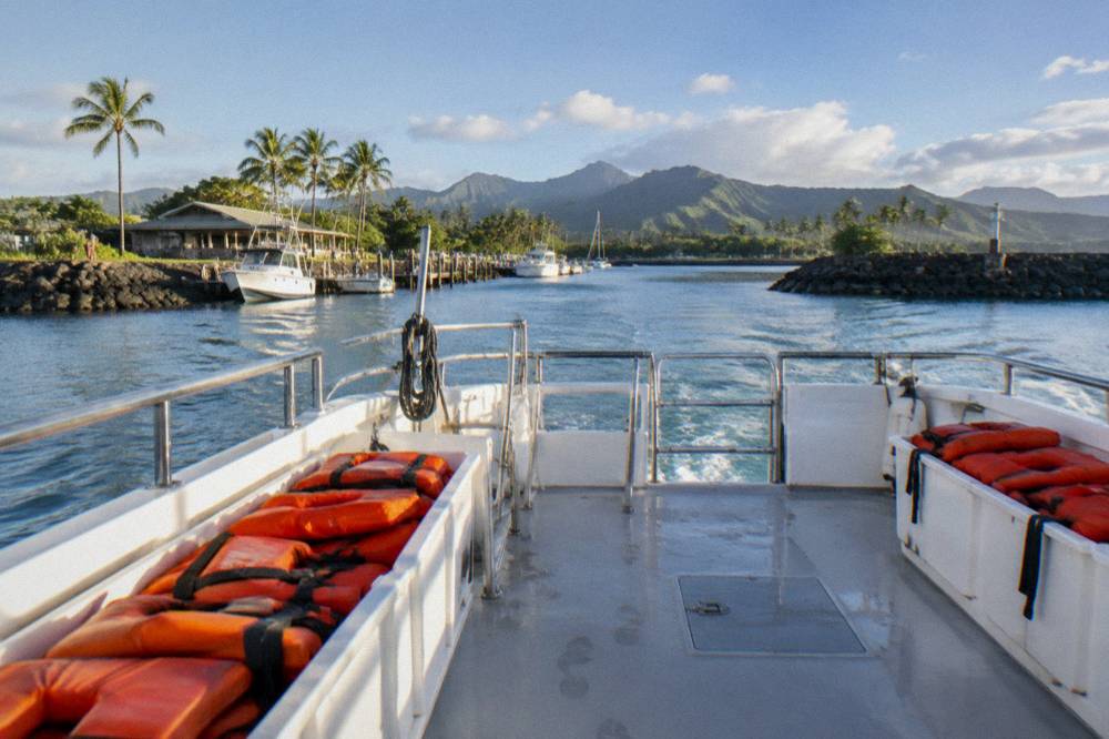 Empty boat deck with life vests stowed and clear walkways before a tour departure